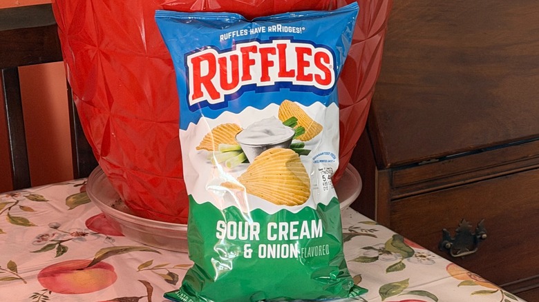 A bag of Ruffles sour cream and onion potato chips