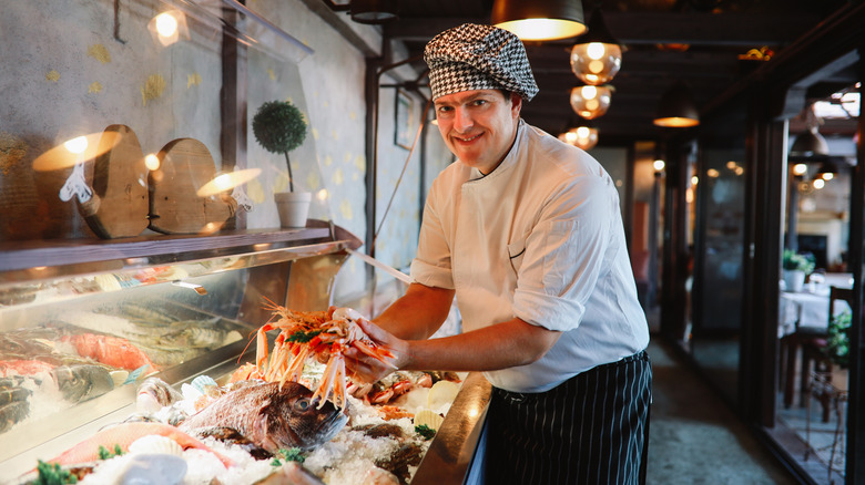 Seafood restaurant chef handling food