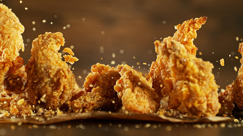 Freeze motion of flying pieces of fried chicken pieces.