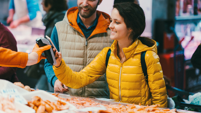 A customer buying shrimp