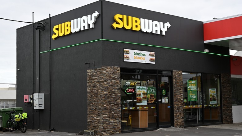 Subway restaurant on the corner attached to a gas station