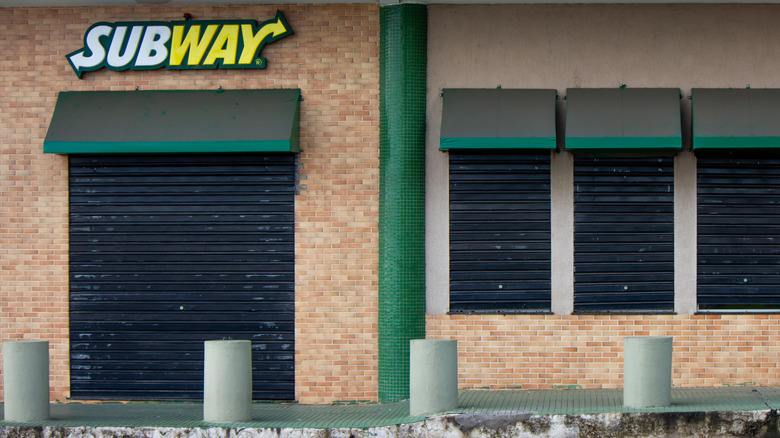A closed Subway restaurant with brick facade