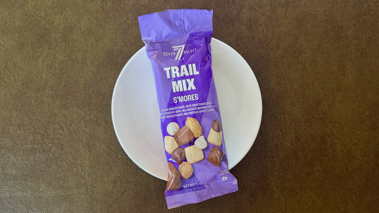 A purple package 7-Select trail mix on a small white plate