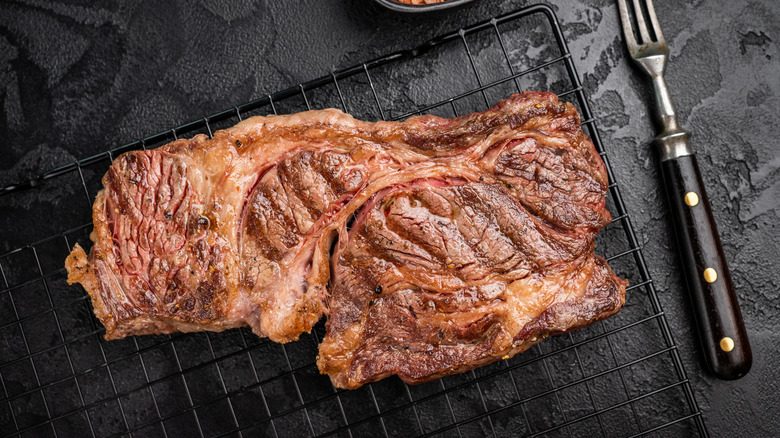 Grilled chuck eye steak on a rack