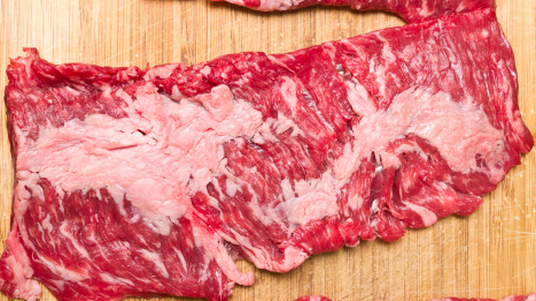 Raw skirt steak on a cutting board