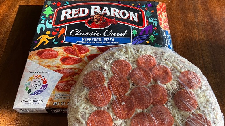 Frozen pepperoni pizza next to a Red Baron pizza box.