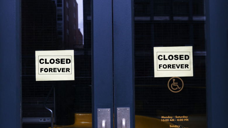 Business with "Closed Forever" sign in door