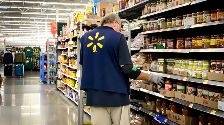 Walmart employee stocking shelf