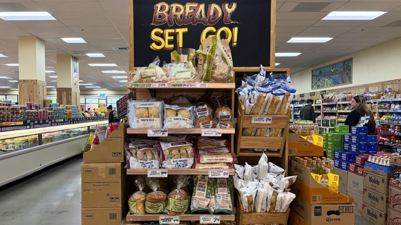 End cap display of bread at Trader Joe's with hand-painted sign that reads "Bready, Set, Go"