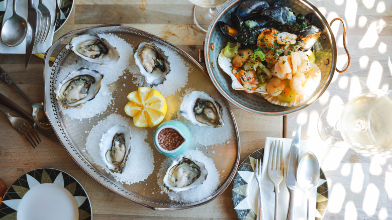 Oysters arranged in salt on tray