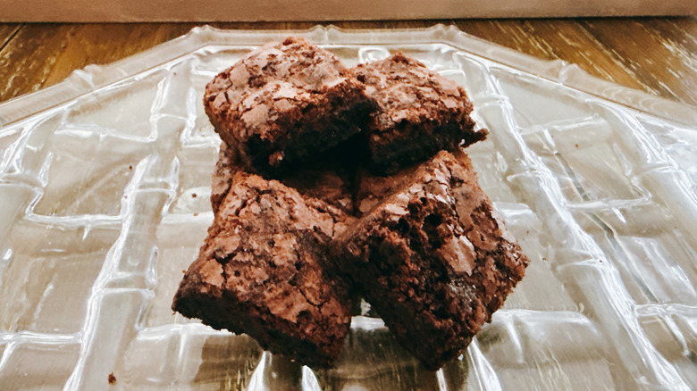 Stack of Trader Joe's sea salt chocolate brownies on a glass plate