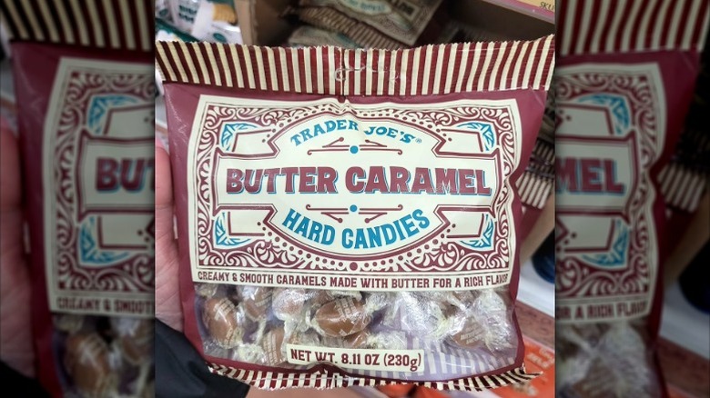 A bag of Trader Joe's Butter Caramel Hard Candies held in hand at the store.