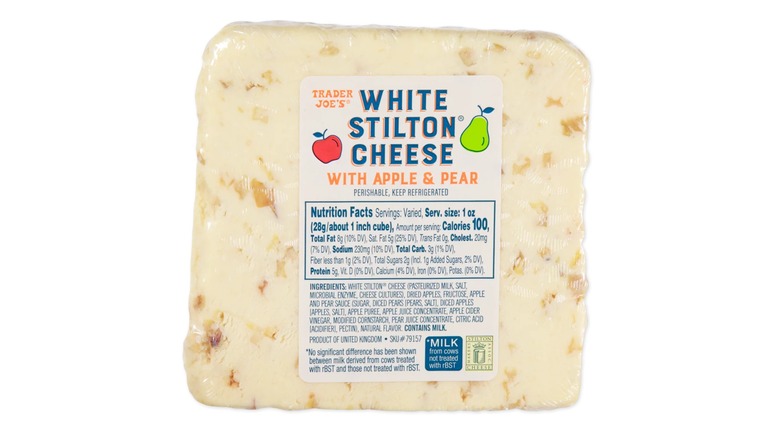 A block of Trader Joe's White Stilton Cheese with Apple and Pear on a white background
