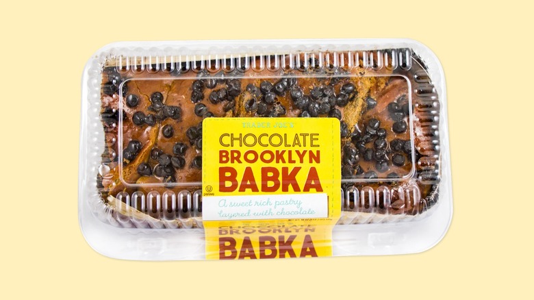 The plastic box containing the Chocolate Brooklyn Babka from Trader Joe's on a yellow background.