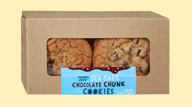 A cardboard box of the Sea Salt Chocolate Chunk Cookies from Trader Joe's on a yellow background.
