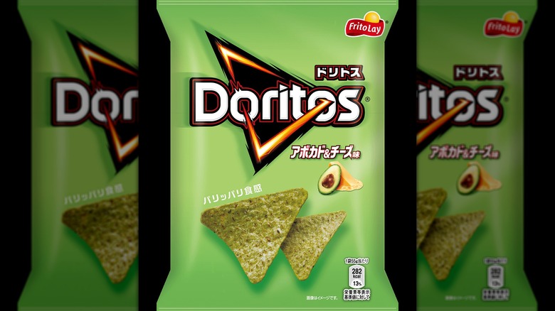Bag of avocado and cheese Doritos with Japanese characters on a black background