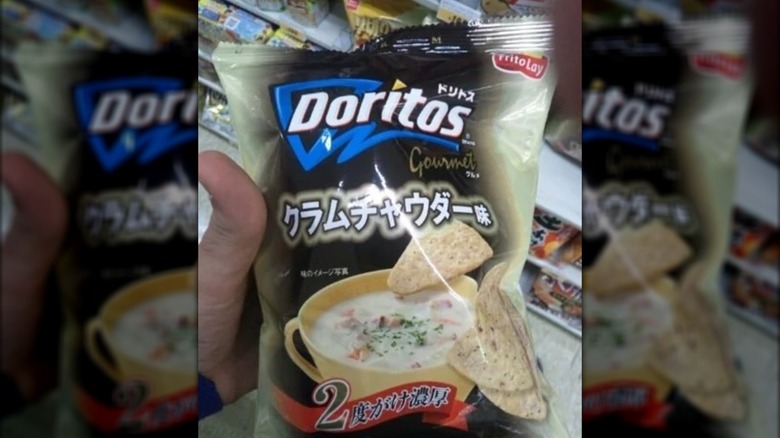 Packet of clam chowder flavor Doritos held by person.