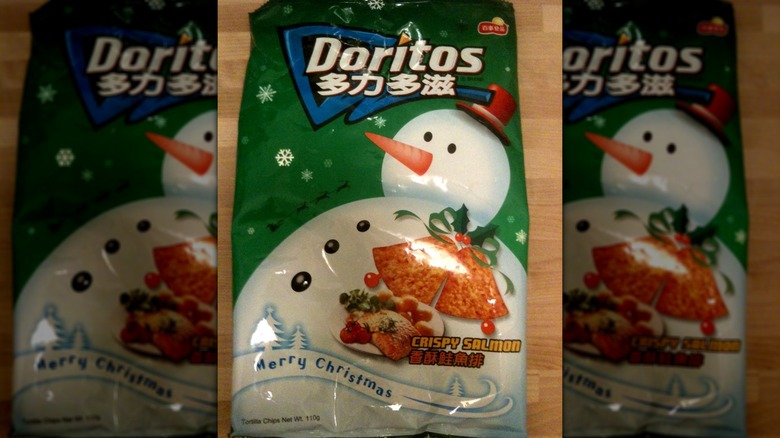 Crispy salmon flavor Doritos on wooden table background.