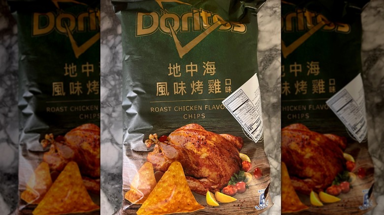 Green packet of roast chicken Doritos on kitchen counter.