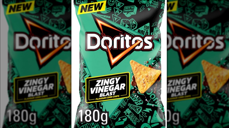 Green bag of Zingy Vinegar Blast flavor Doritos on white background.