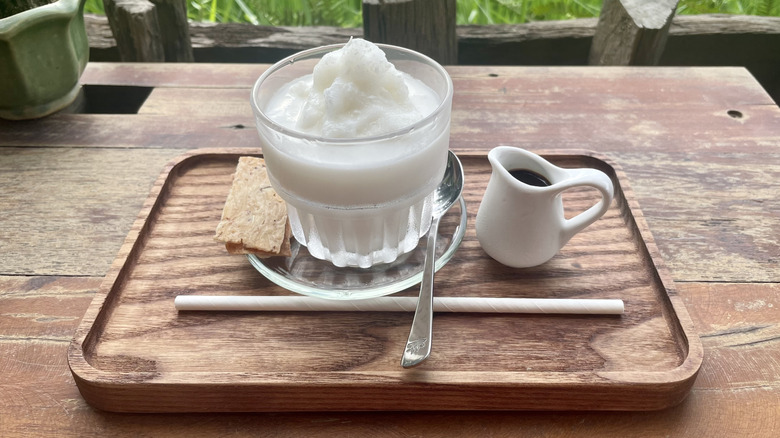Coconut mixture by coffee shot overlooking beautiful green rice field