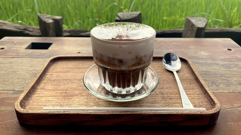 Salt coffee with tree decor on table overlooking rice fields