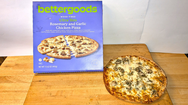 A freshly cooked bettergoods wood-fired ultra thin rosemary and garlic chicken beside the box it came in