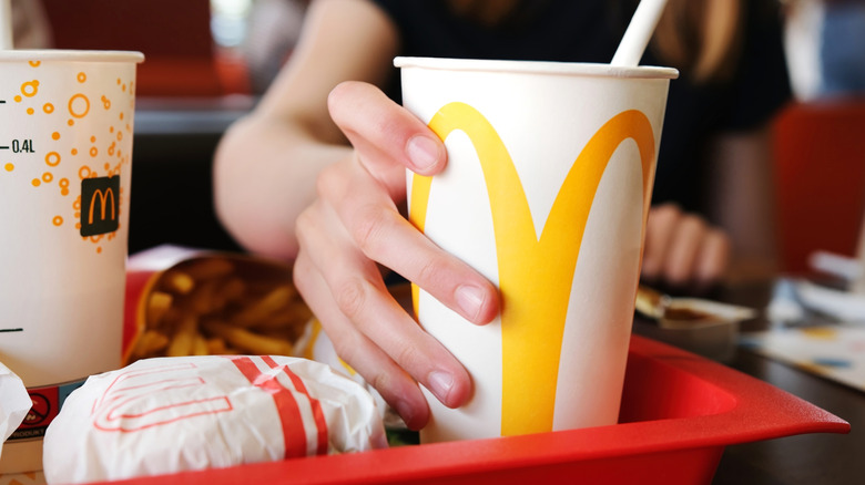 hand holding McDonald's beverage cup