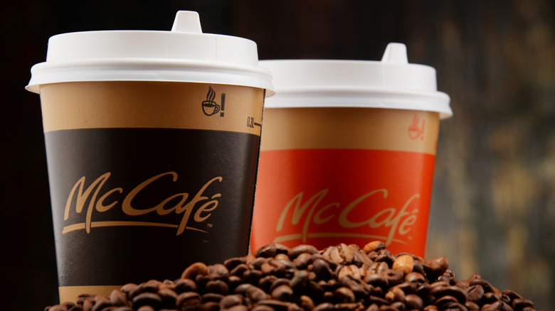 two cups of McDonald's coffee on top of coffee beans