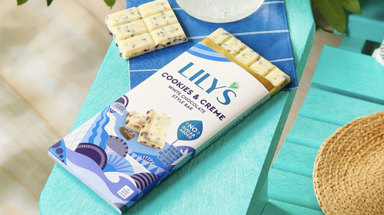 Opened Lily's chocolate bar on a turquoise outdoor chair