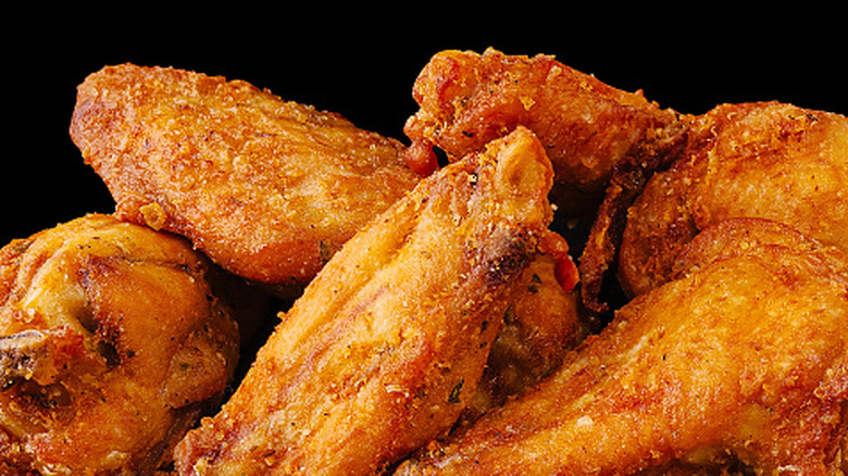 Close up of chicken wings with black background