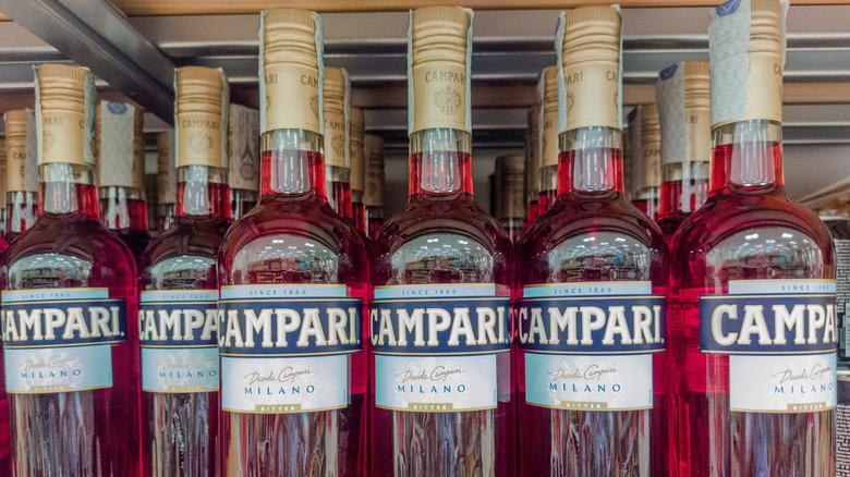 Bottles of Campari Italian Apertif in rows on retail display