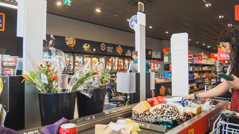 Shoppers at checkout at an Aldi