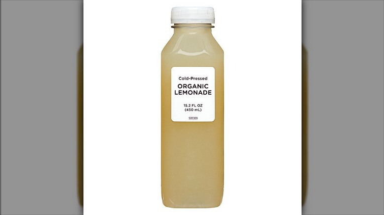 Plastic bottle of Aldi Organic Cold Pressed Lemonade on a white background.
