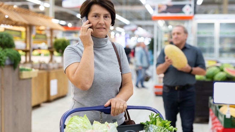 woman talking on phone in grocery store