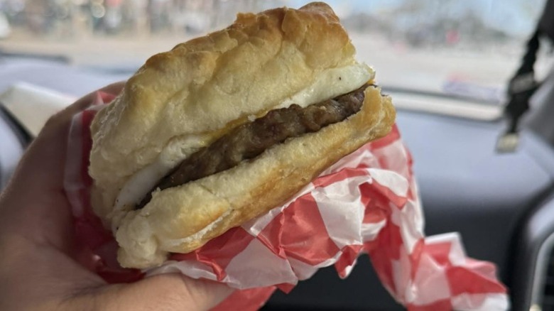 Hand holding a Buc-ee's sausage biscuit