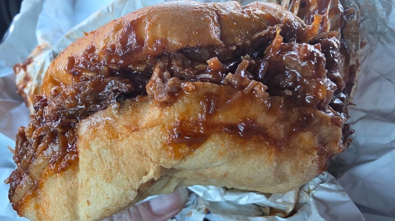 hand holding a Buc-ee's brisket sandwich