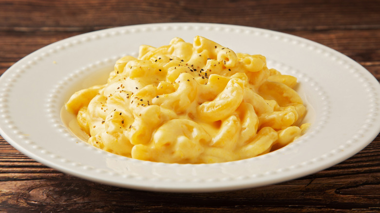 Macaroni and cheese in a white bowl on a wooden table