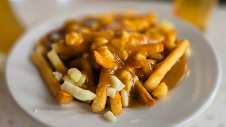 Canadian comfort food poutine on a white plate