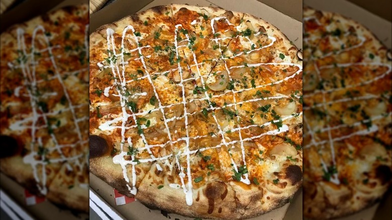 whole pizza with mushrooms and drizzled with white sauce from Marsigliano's Pizzeria & More
