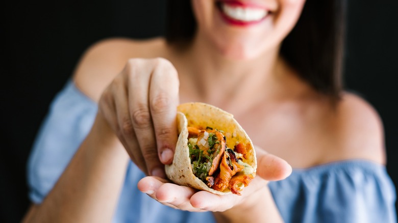 Woman holding a homemade taco in her hand