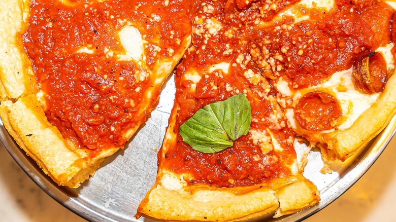 An overhead view of a Chicago-style pizza on a metal pizza pan from Emmett's restaurant