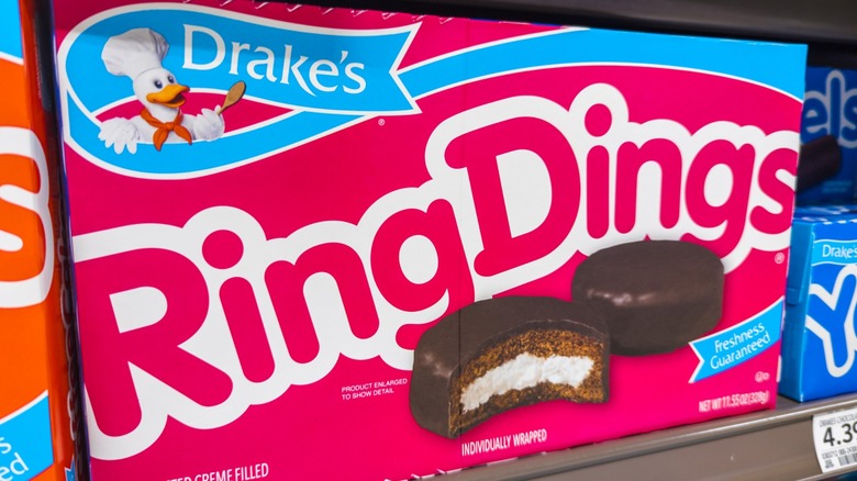 A close-up of a box of Drake's Ring Dings on a grocery store shelf