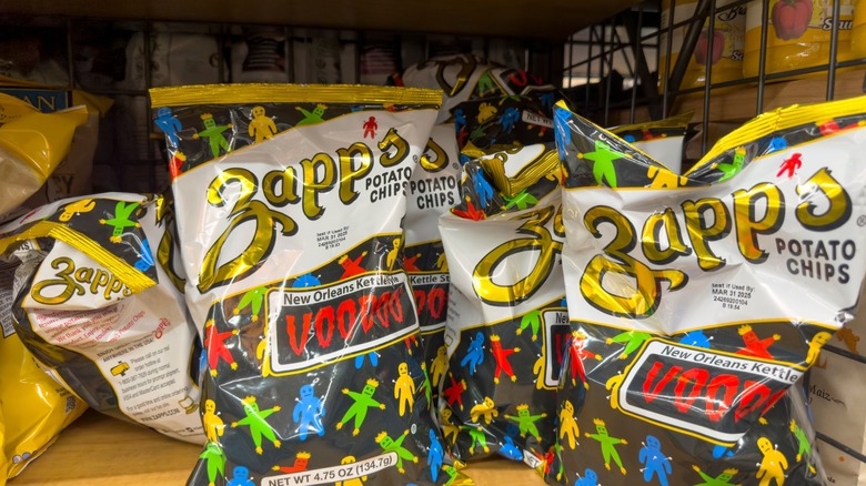 Individual bags of Zapp's potato chips on a convenience store shelf