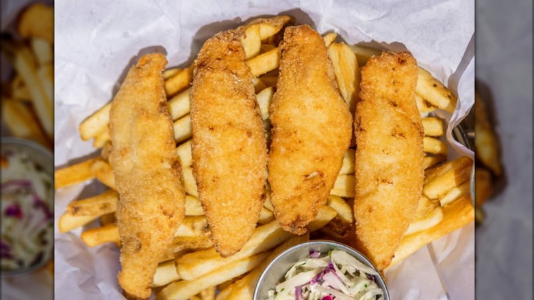 Four pieces of Ivar's fried fish on top of pile of fries.