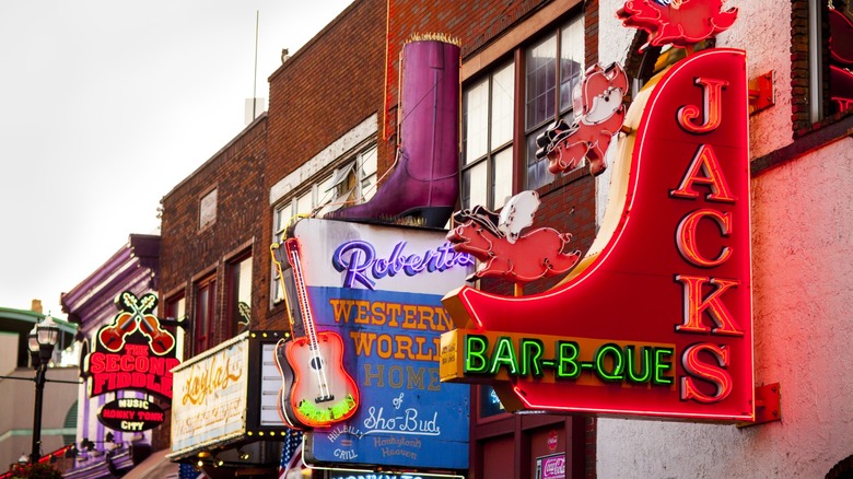 View of country western neon signs on Lower Broadway street in Nashville, Tennessee including Jack's Bar B Que and Robert's Western World