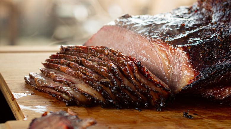 Wagyu brisket sliced on a wooden cutting board