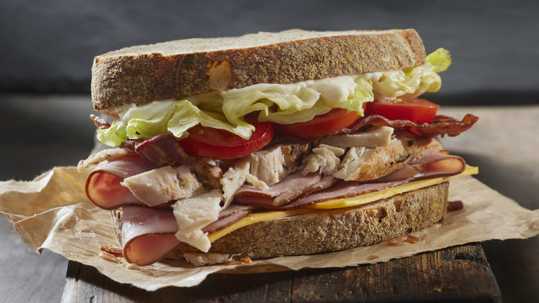 Roast Chicken BLT with Black Forest Ham, Bacon, Cheddar Cheese, Lettuce, Tomato, and Mayo on Whole Wheat Sourdough