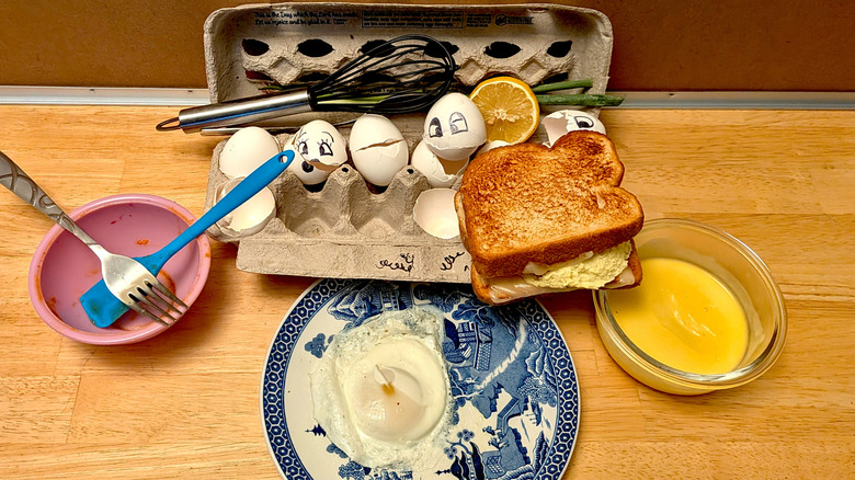 A selection of dirty utensils, broken egg shells, and different styles of egg cooked in the microwave