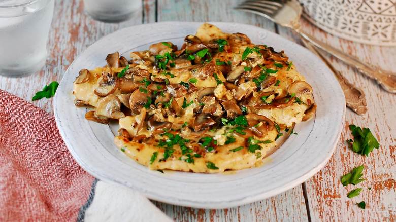 Plate of chicken Marsala with mushrooms and fresh parsley